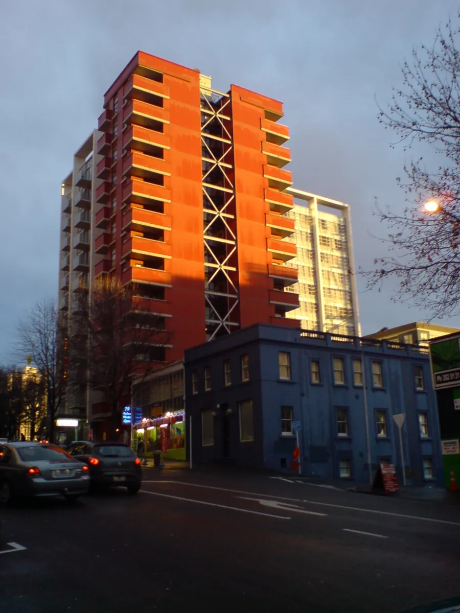 A tall skyscraper viewed from below, showing dramatic three-point perspective