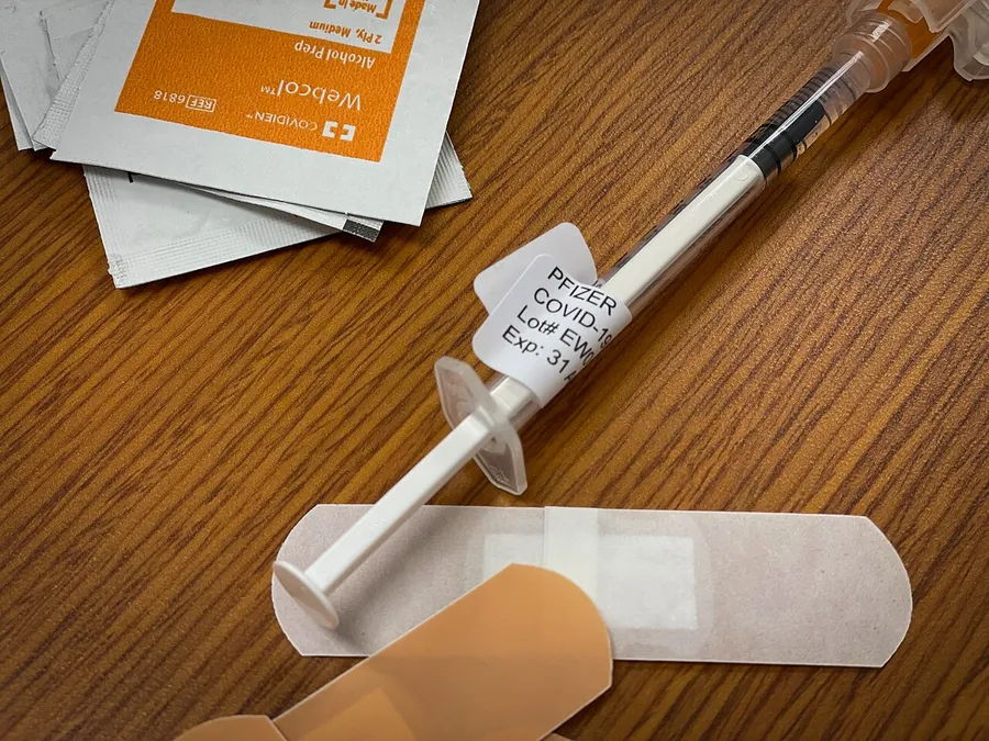 A friendly cartoon of a child getting a vaccine from a doctor