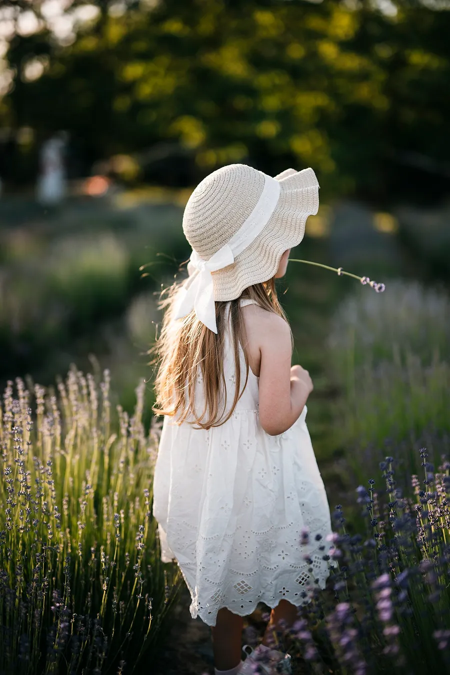 A child wearing a sun hat to protect their skin on a bright day