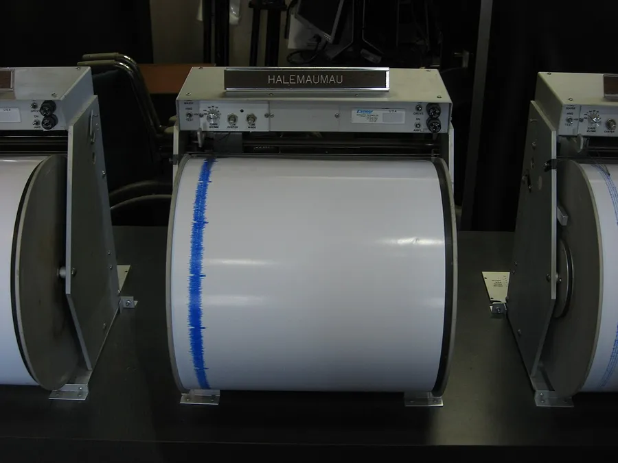 A seismometer drawing wavy lines that record earthquake shaking