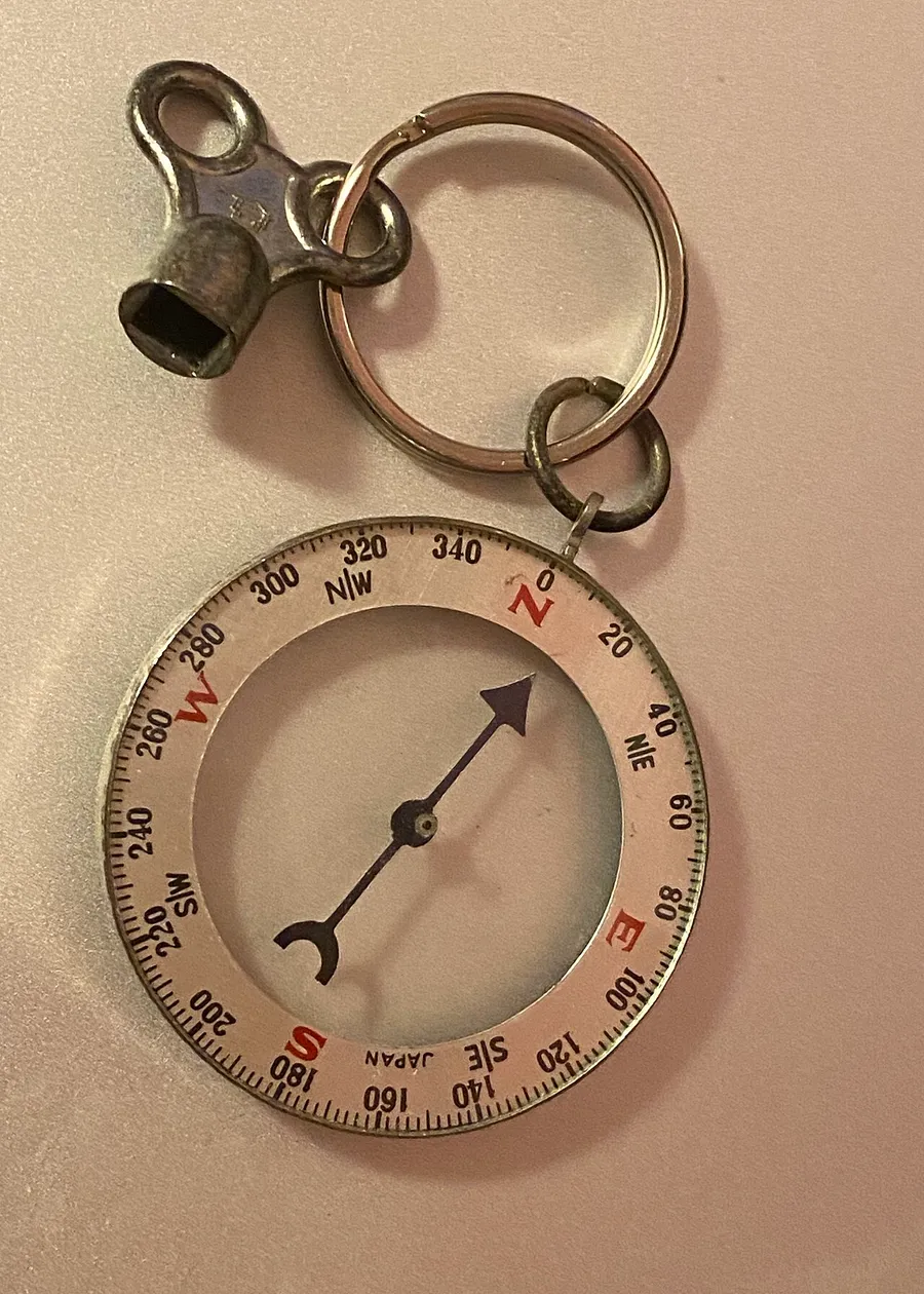 A magnetic compass with its needle pointing north