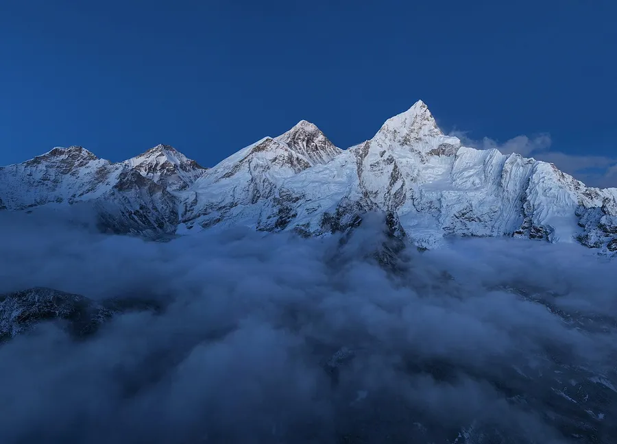 The snow-covered summit of Mount Everest towering into the sky