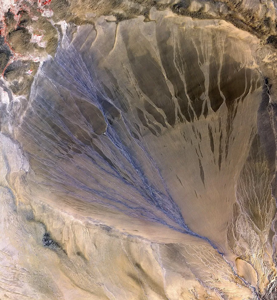 A fan-shaped river delta where the river meets the sea