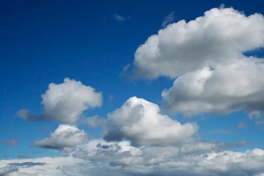 Big fluffy white clouds drifting across a blue sky