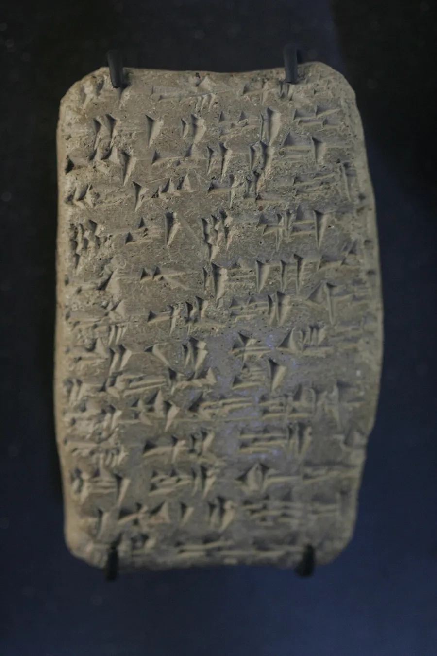 An ancient clay tablet covered in wedge-shaped cuneiform writing