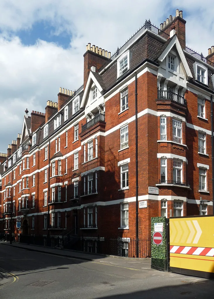 Rows of brick buildings in a crowded Victorian industrial city