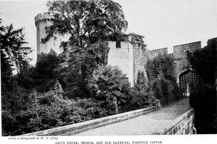 A heavy iron portcullis gate set in a castle's stone gatehouse
