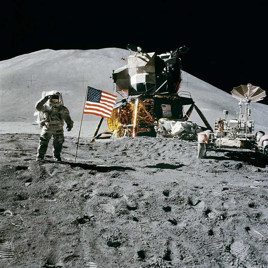 An astronaut standing on the grey surface of the Moon during the Apollo landing