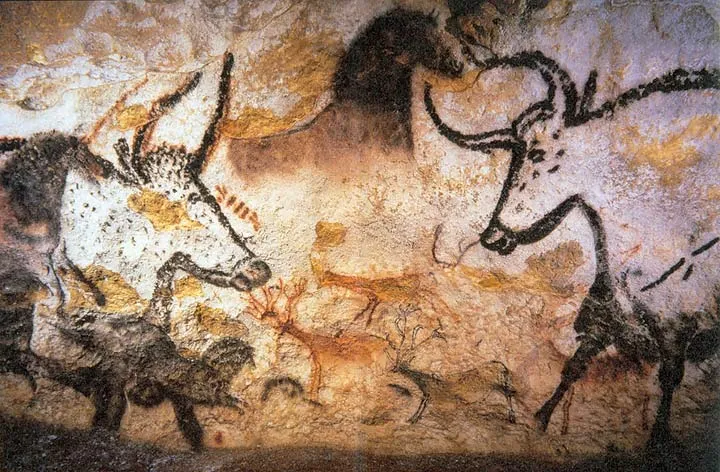 Ancient cave paintings of animals drawn on a rock wall