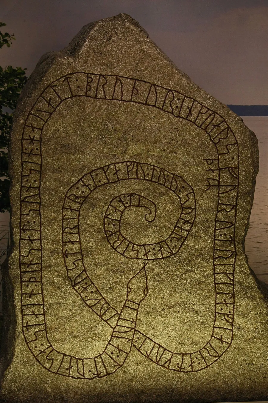 An old Viking rune stone carved with Norse symbols