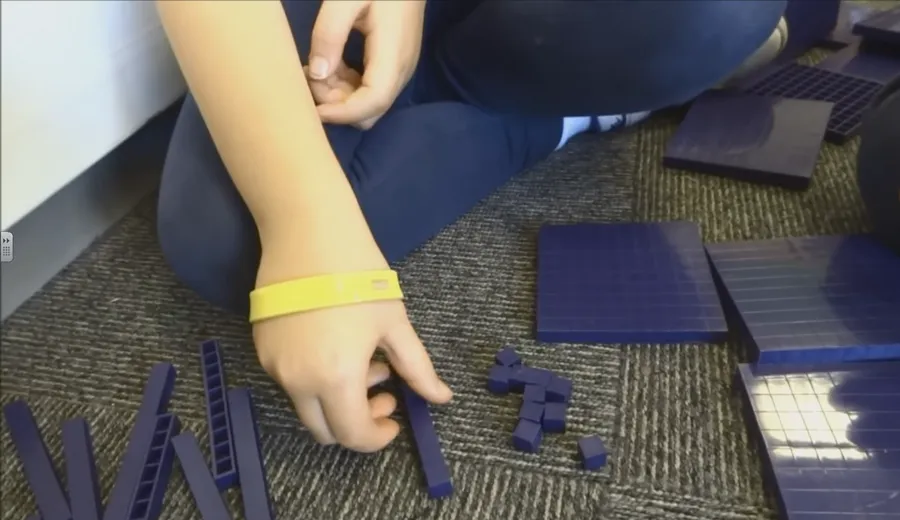 Base-ten blocks showing a ten being exchanged for ten ones to borrow