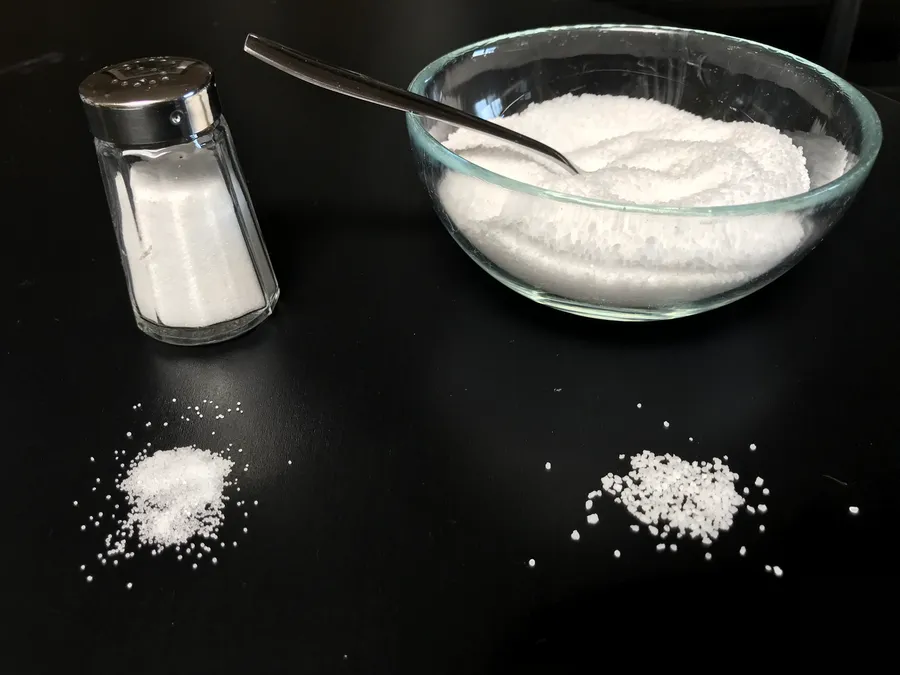 Close-up of white table salt crystals made of sodium and chlorine