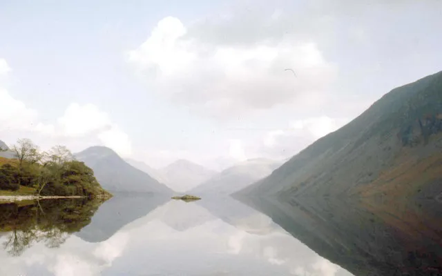 A perfect reflection of the scenery in a calm, mirror-like lake