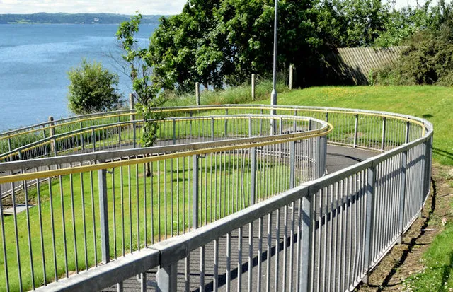 A sloping wheelchair ramp, an inclined plane leading to a doorway