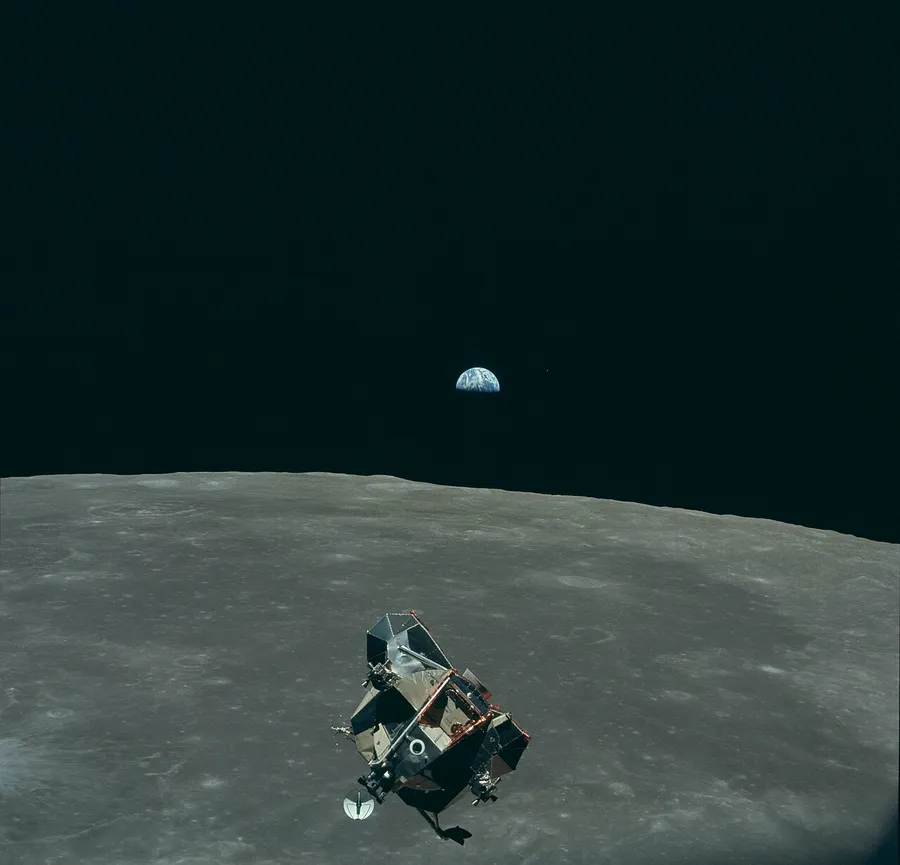 The Moon circling the Earth, held in orbit by gravity