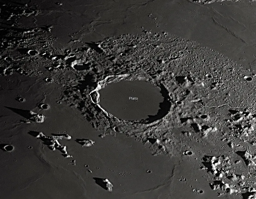 Bowl-shaped craters covering the grey, dusty surface of the Moon
