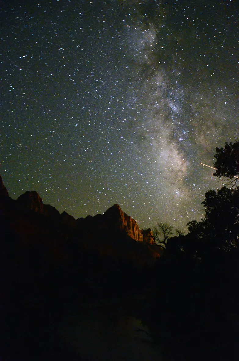 Streaks of shooting stars during a meteor shower in the night sky